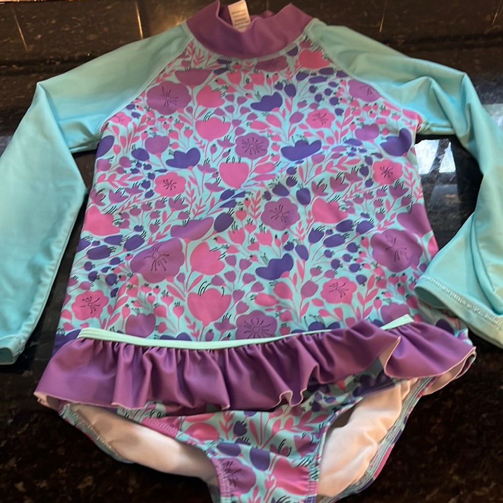 Size 8 purple, pink, and mint rash guard swimsuit.